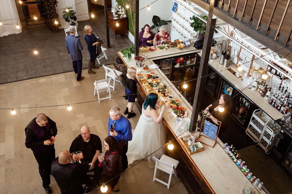 An overhead view of guests gathered at the venue bar