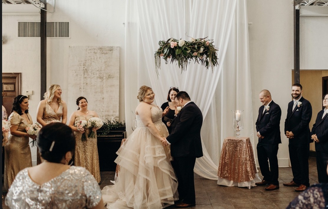 A wedding ceremony in the white-walled bank hall