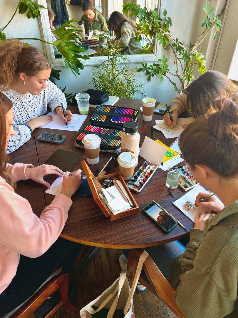 Community members making art together around a table